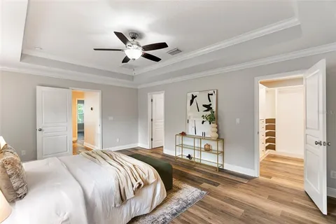 a bedroom with a large bed and a chandelier