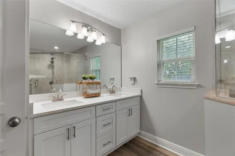 a bathroom with a double vanity sink and a mirror
