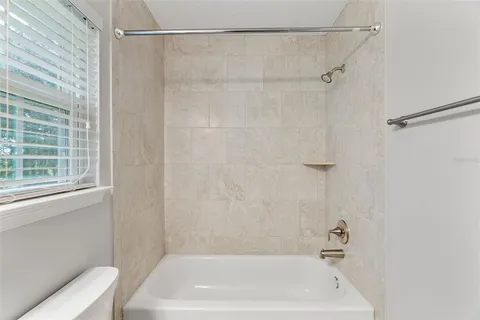a bathroom with a shower and a bath tub