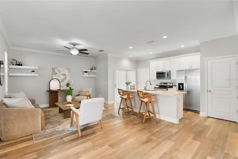 a living room with furniture and kitchen view