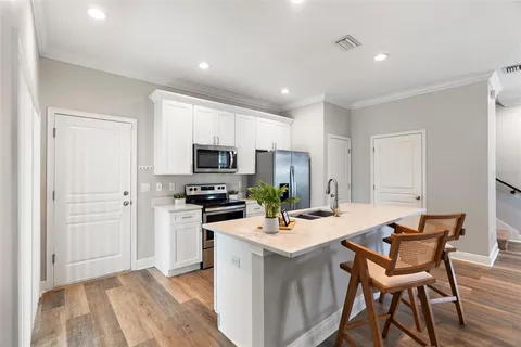 a kitchen with a dining table chairs and refrigerator