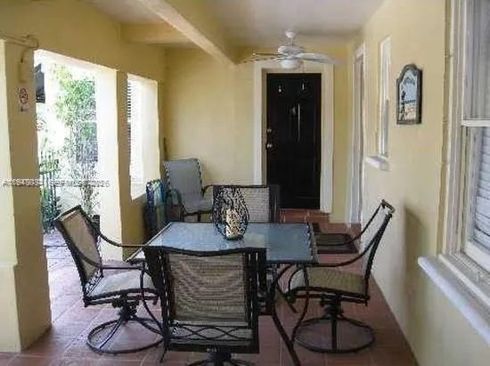 a front view of a house with plants