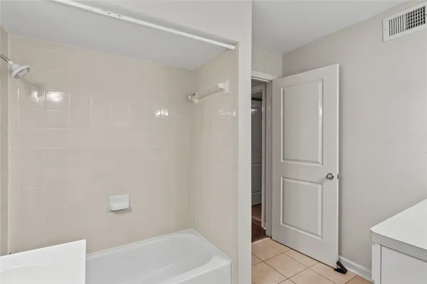 a bathroom with a bathtub and shower