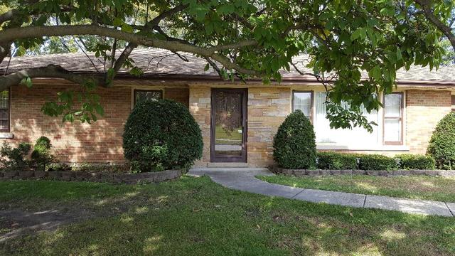7620 West 25th Street North Riverside, IL 60546 - Photo 2 of 33 a front view of a house with garden