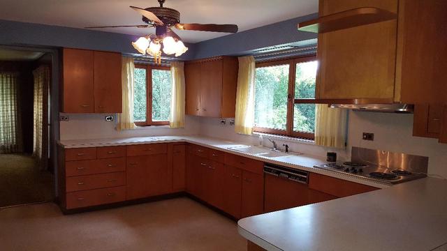 7620 West 25th Street North Riverside, IL 60546 - Photo 18 of 33 a kitchen with stainless steel appliances granite countertop sink and window