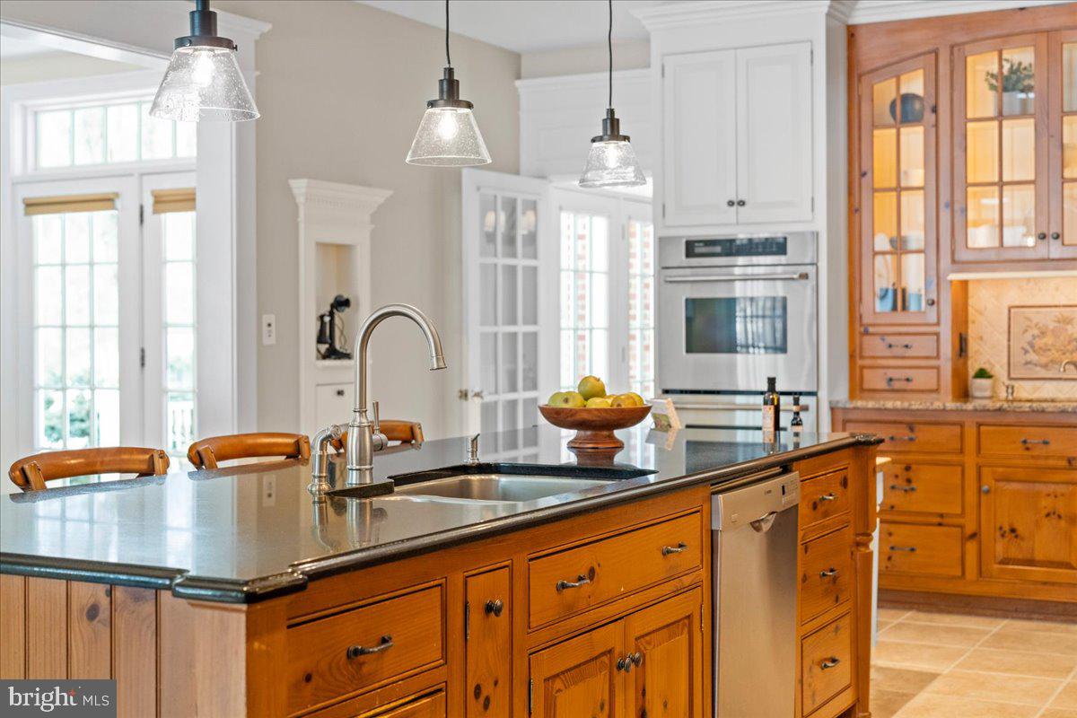 1568 Sacketts Ford Road Ivyland, PA 18974 - Photo 18 of 100 a kitchen with stainless steel appliances granite countertop a sink a stove and a granite counter tops with white cabinets