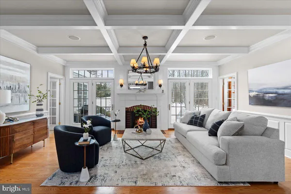 a living room with furniture flowerpot and wooden floor