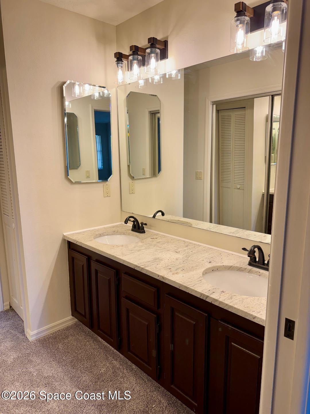 810 Ridge Lake Drive Melbourne, FL 32940 - Photo 17 of 25 a bathroom with a double vanity sink and a mirror