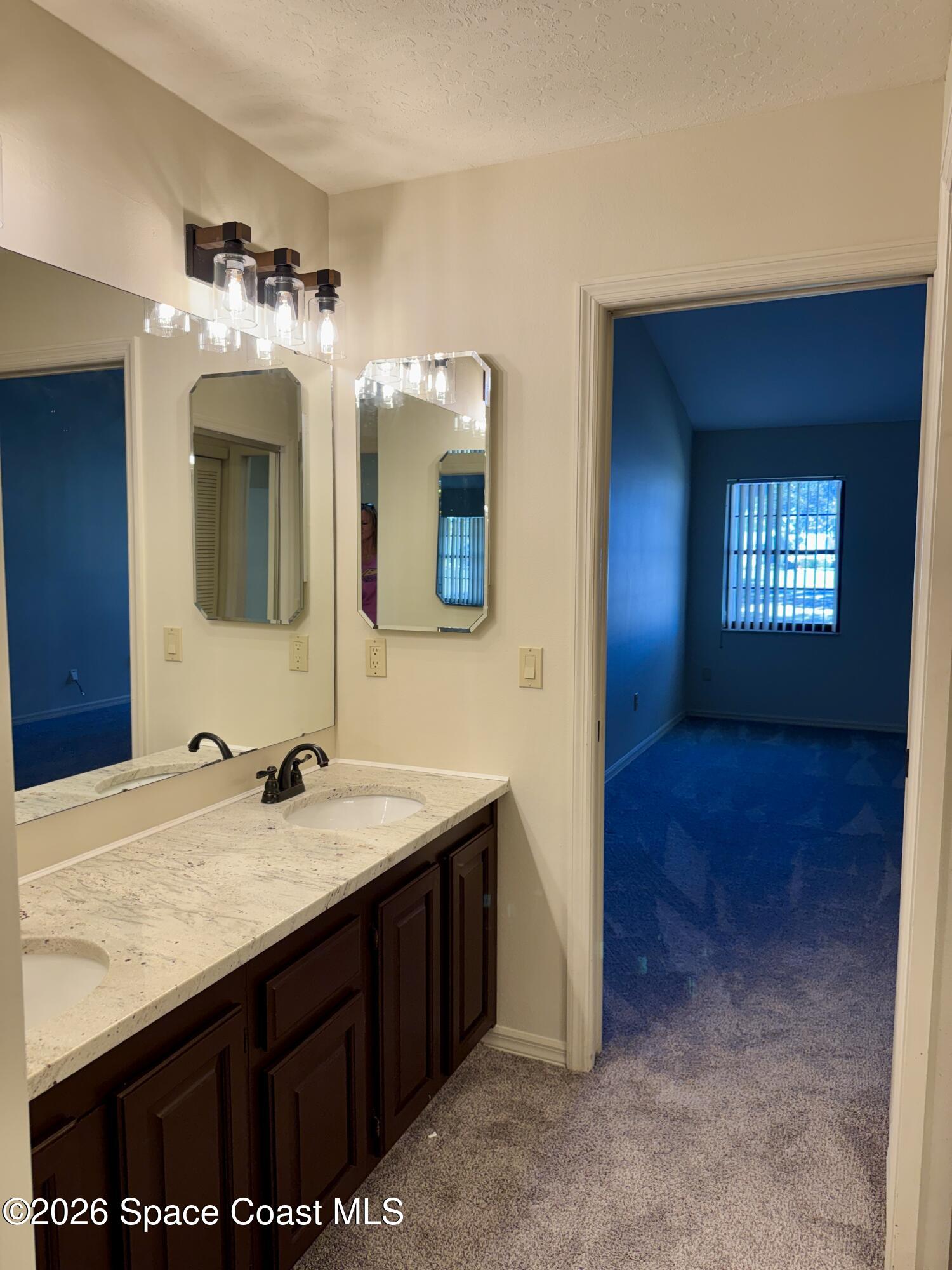 810 Ridge Lake Drive Melbourne, FL 32940 - Photo 18 of 25 a bathroom with a sink and a mirror