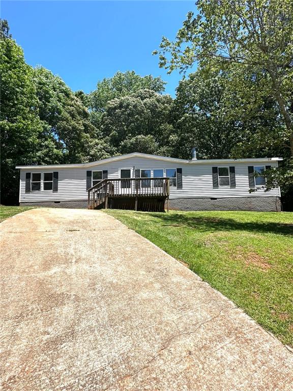 a view of house with swimming pool and yard