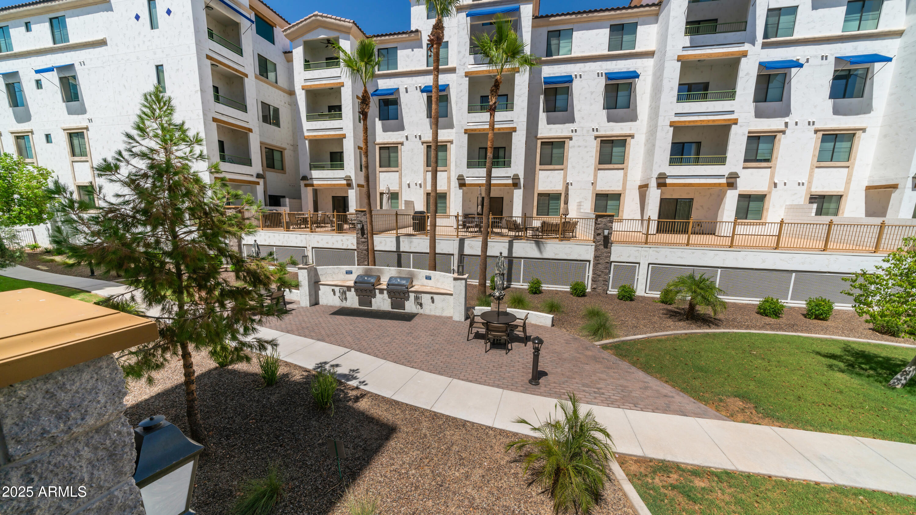 2511 West Queen Creek Road, Unit 166 Chandler, AZ 85248 - Photo 28 of 66 a view of tall buildings and a yard