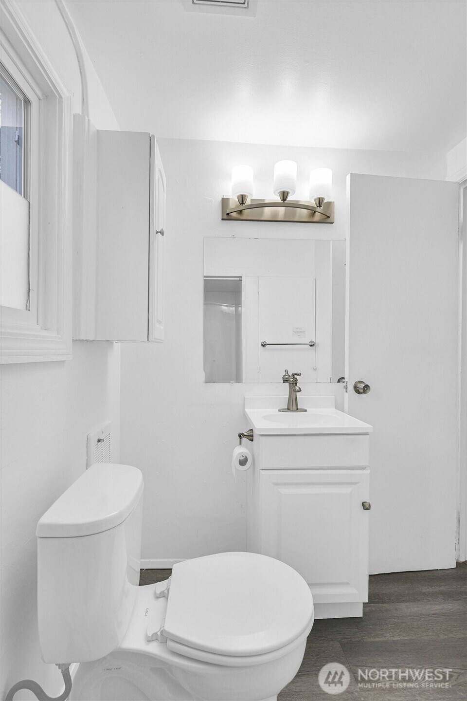 16030 15th Avenue Southwest Burien, WA 98166 - Photo 10 of 19 a bathroom with a sink a toilet and mirror
