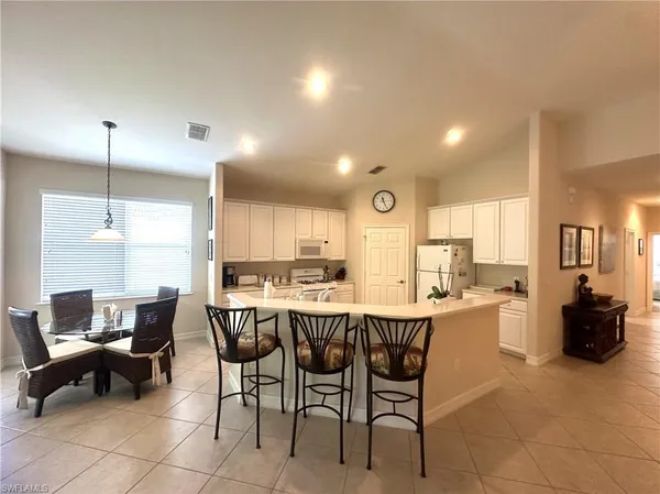 a large kitchen with a table and chairs