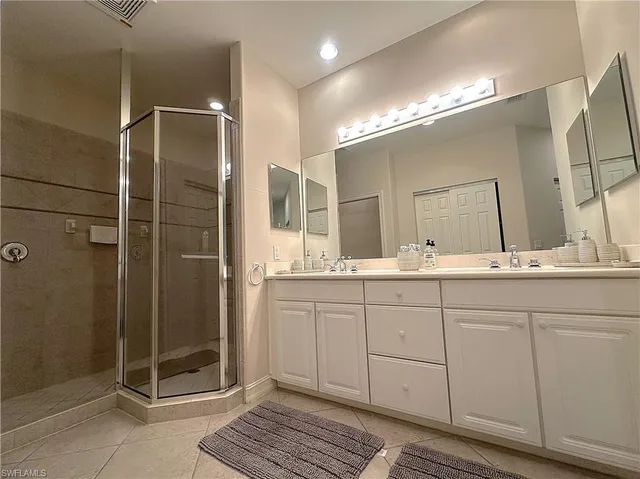 a bathroom with a double vanity sink and a mirror