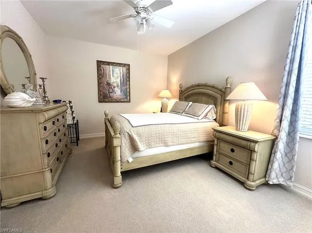 a spacious bedroom with a bed and a dresser