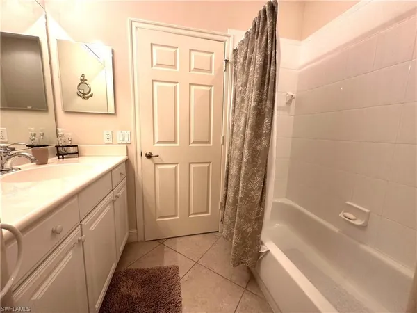 a bathroom with a sink a mirror and a bathtub