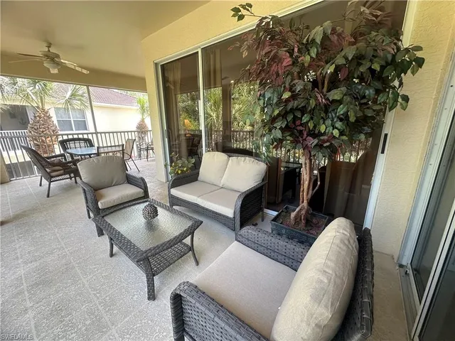 a outdoor living room with furniture and a potted plant