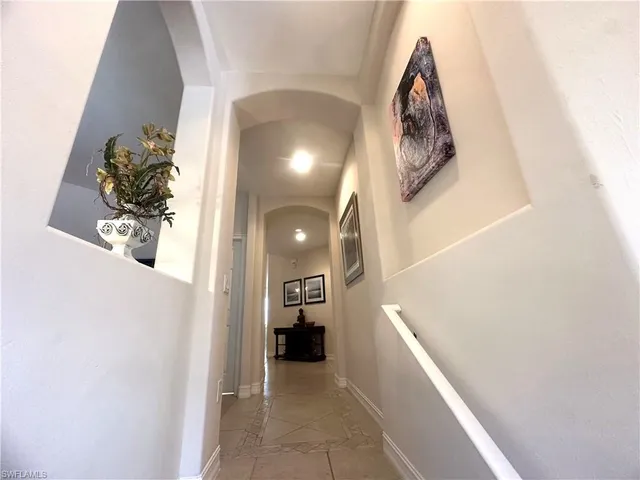 a view of a hallway with entryway and furniture