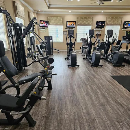 a room with table chairs and wooden floor