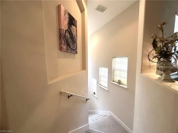 a view of a hallway with paintings on the wall