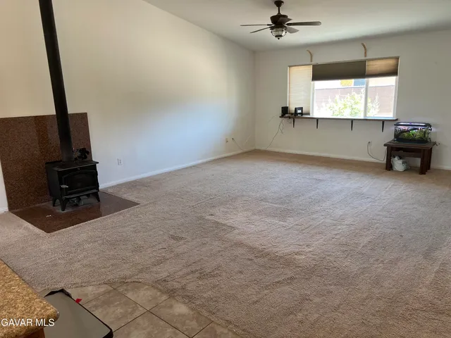 a view of room with window and a ceiling fan