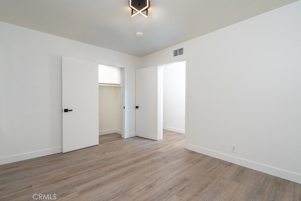6026 Moraga Avenue Riverside, CA 92509 - Photo 14 of 42 a view of an empty room with wooden floor
