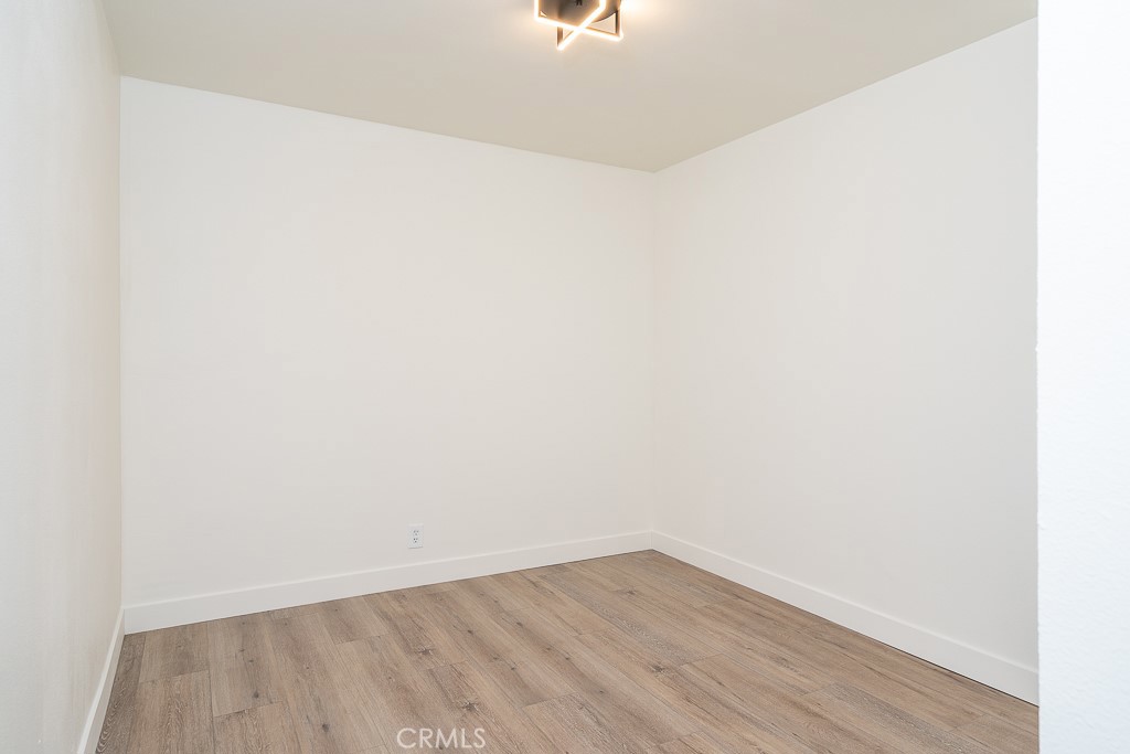 6026 Moraga Avenue Riverside, CA 92509 - Photo 19 of 42 a view of an empty room with wooden floor
