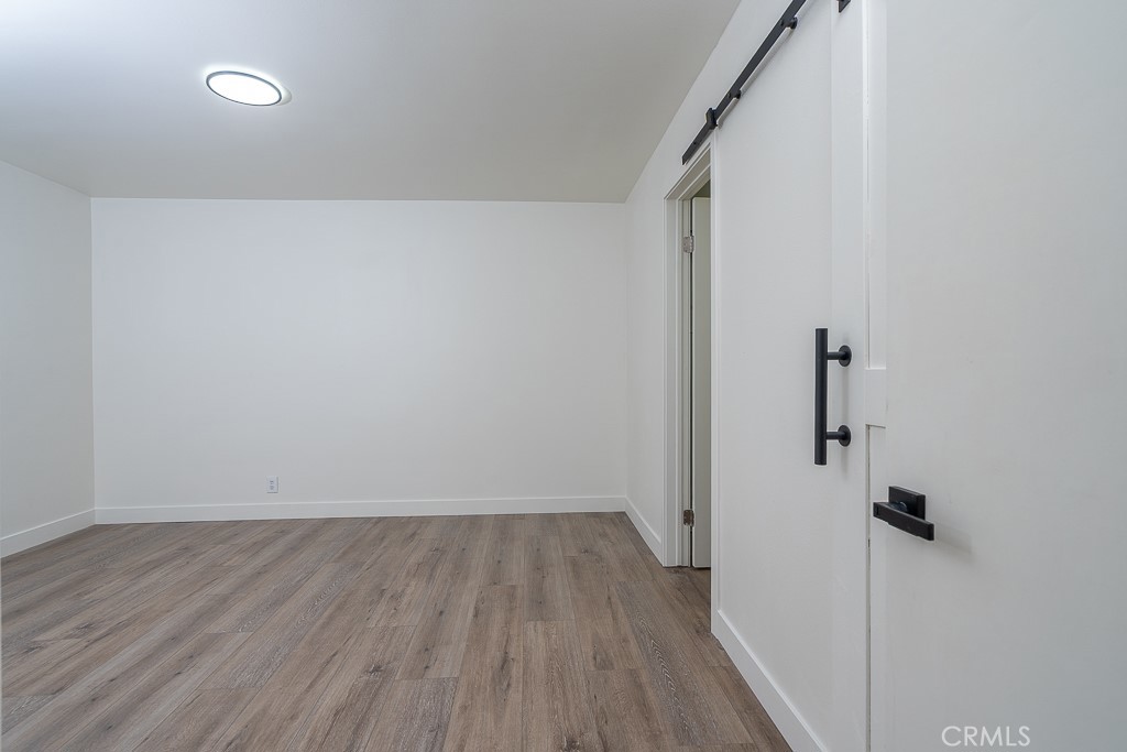 6026 Moraga Avenue Riverside, CA 92509 - Photo 27 of 42 a view of room with wooden floor