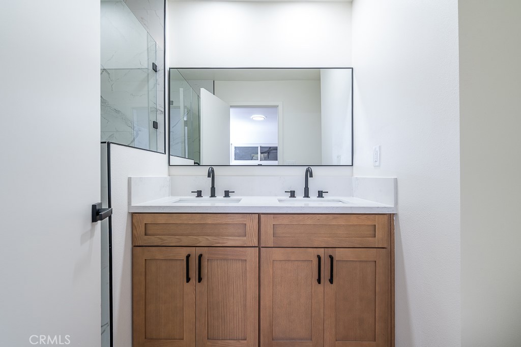 6026 Moraga Avenue Riverside, CA 92509 - Photo 28 of 42 a bathroom with a sink vanity and mirror