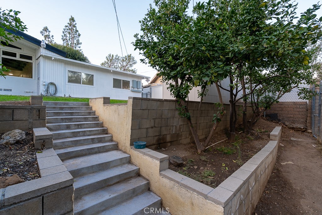 6026 Moraga Avenue Riverside, CA 92509 - Photo 31 of 42 a view of a backyard with wooden fence and a large tree