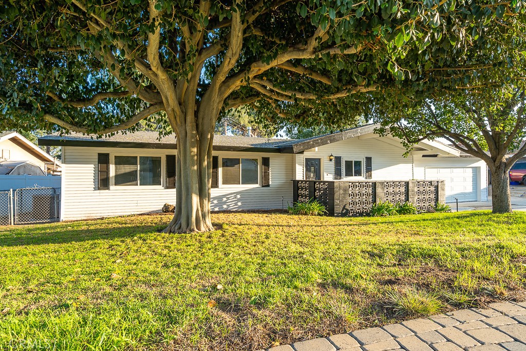 6026 Moraga Avenue Riverside, CA 92509 - Photo 38 of 42 a front view of a house with a garden