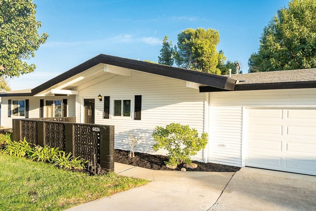 6026 Moraga Avenue Riverside, CA 92509 - Photo 4 of 42 a front view of a house with a yard