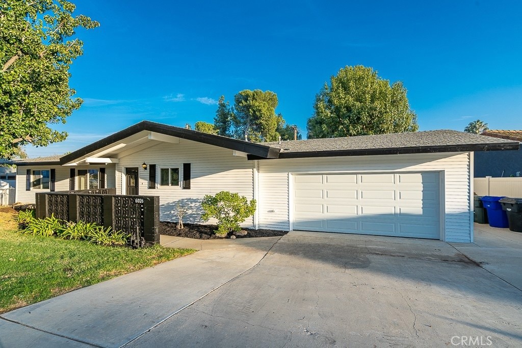 6026 Moraga Avenue Riverside, CA 92509 - Photo 5 of 42 a front view of a house with a yard and garage