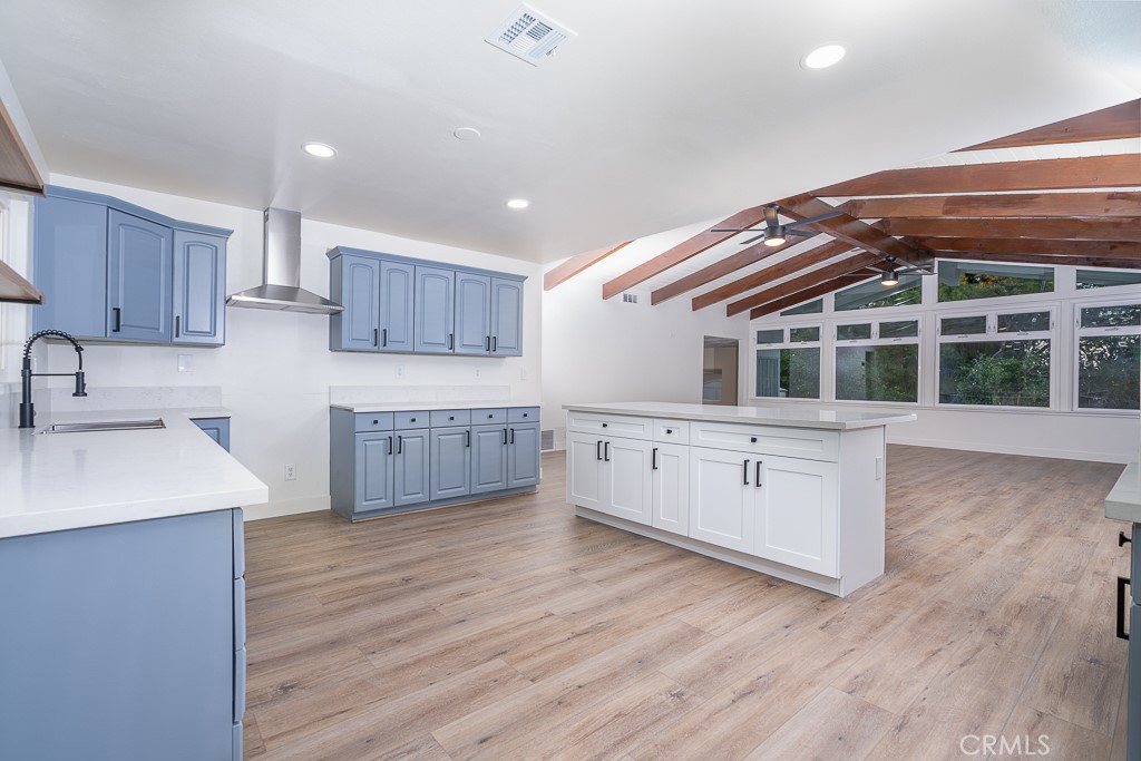 6026 Moraga Avenue Riverside, CA 92509 - Photo 10 of 42 a kitchen with wooden floors and wooden cabinets