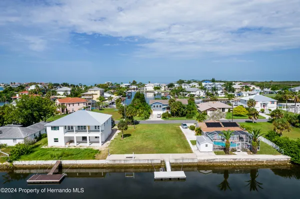 an aerial view of a house with swimming pool outdoor seating and yard