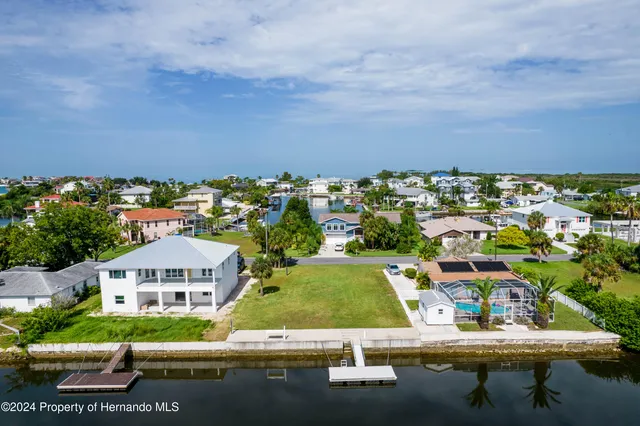 an aerial view of a house with swimming pool outdoor seating and yard