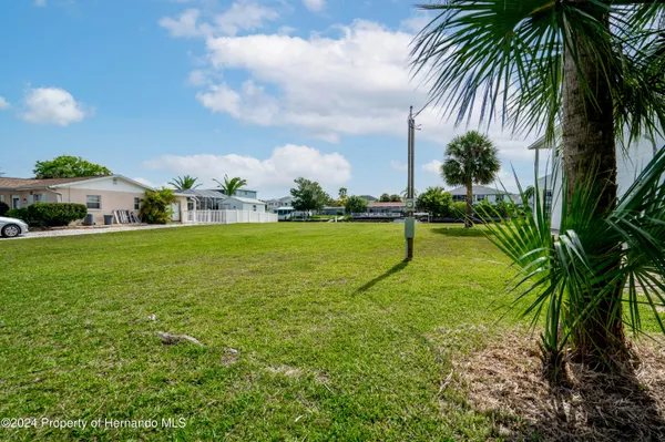 a view of a lake with outdoor seating space