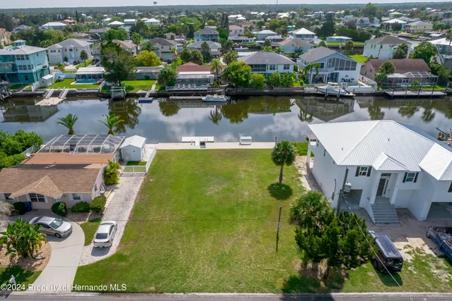 an aerial view of a house with a lake view