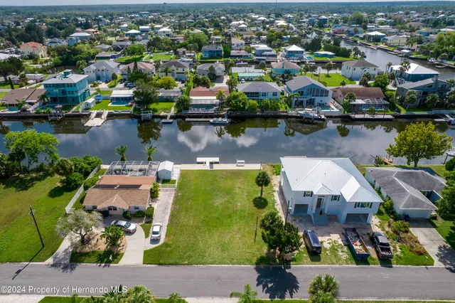 an aerial view of a house with a lake view