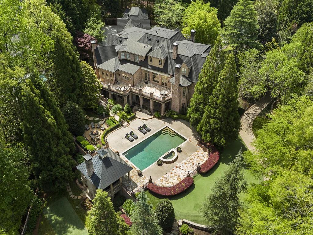 an aerial view of a house with a swimming pool and garden view