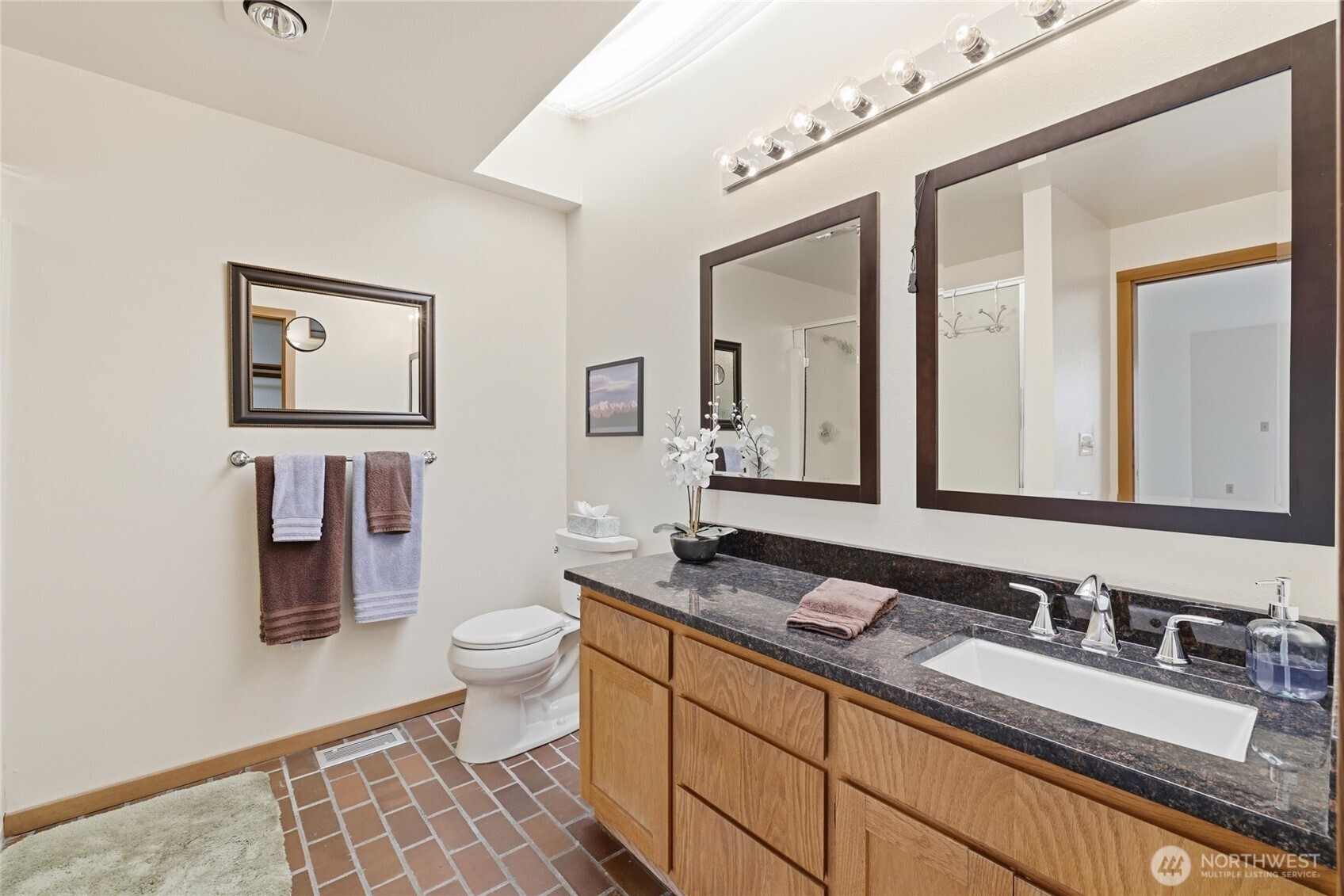 9520 Odin Way Bothell, WA 98011 - Photo 17 of 40 a bathroom with a granite countertop sink mirror and toilet