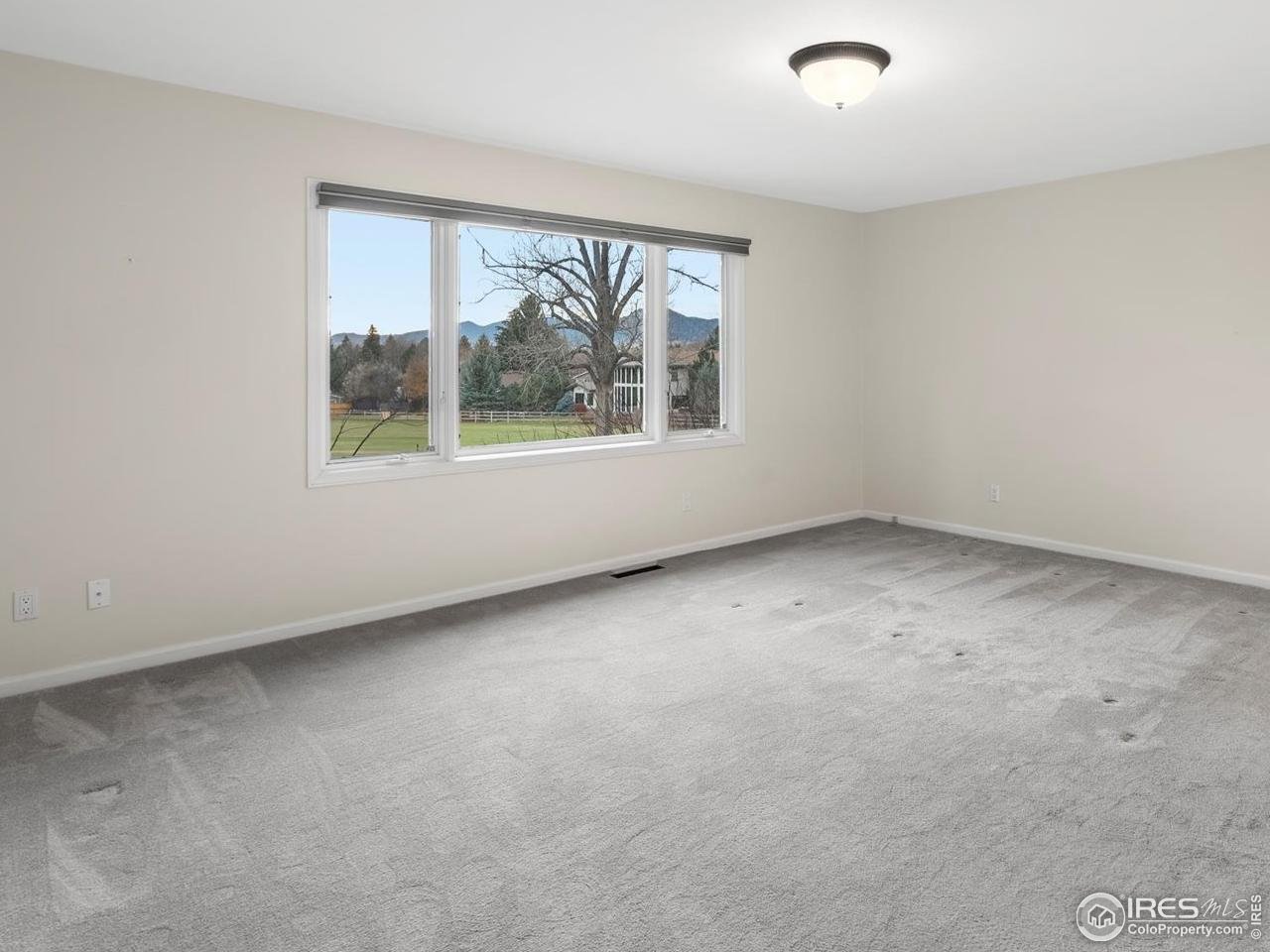 6972 Roaring Fork Trail Boulder, CO 80301 - Photo 18 of 35 an empty room with windows