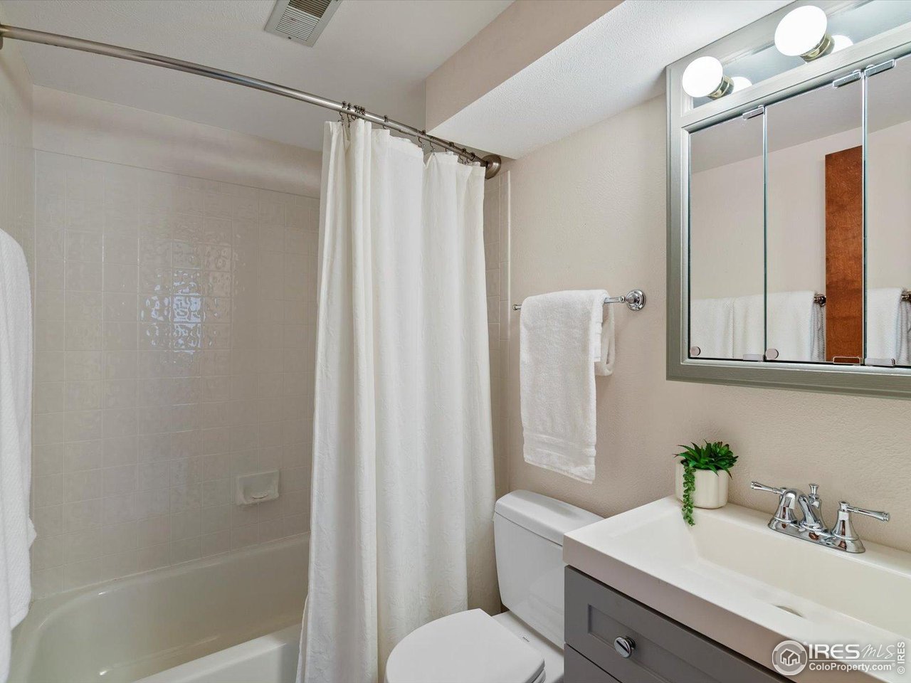 6972 Roaring Fork Trail Boulder, CO 80301 - Photo 27 of 35 a bathroom with a sink mirror and a shower