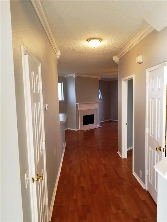 1100 Raleigh Drive Lewisville, TX 75077 - Photo 2 of 19 wooden floor in an empty room with a fireplace