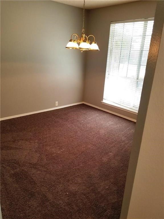 1100 Raleigh Drive Lewisville, TX 75077 - Photo 4 of 19 en empty room with windows and chandelier