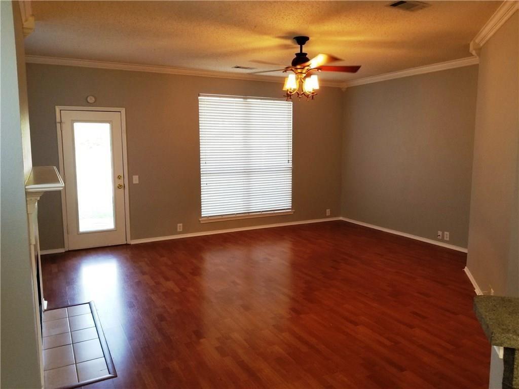 1100 Raleigh Drive Lewisville, TX 75077 - Photo 8 of 19 an empty room with wooden floor and windows