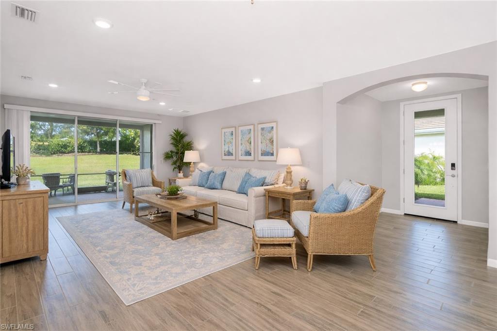 14559 Edgewater Circle Naples, FL 34114 - Photo 9 of 49 a living room with furniture and a wooden floor