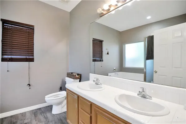 a bathroom with a sink toilet and vanity
