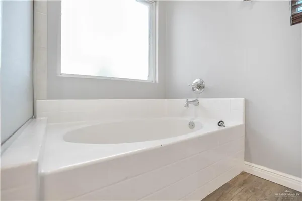 a bathroom with bathtub and window