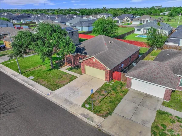 an aerial view of a house with a garden and lake view